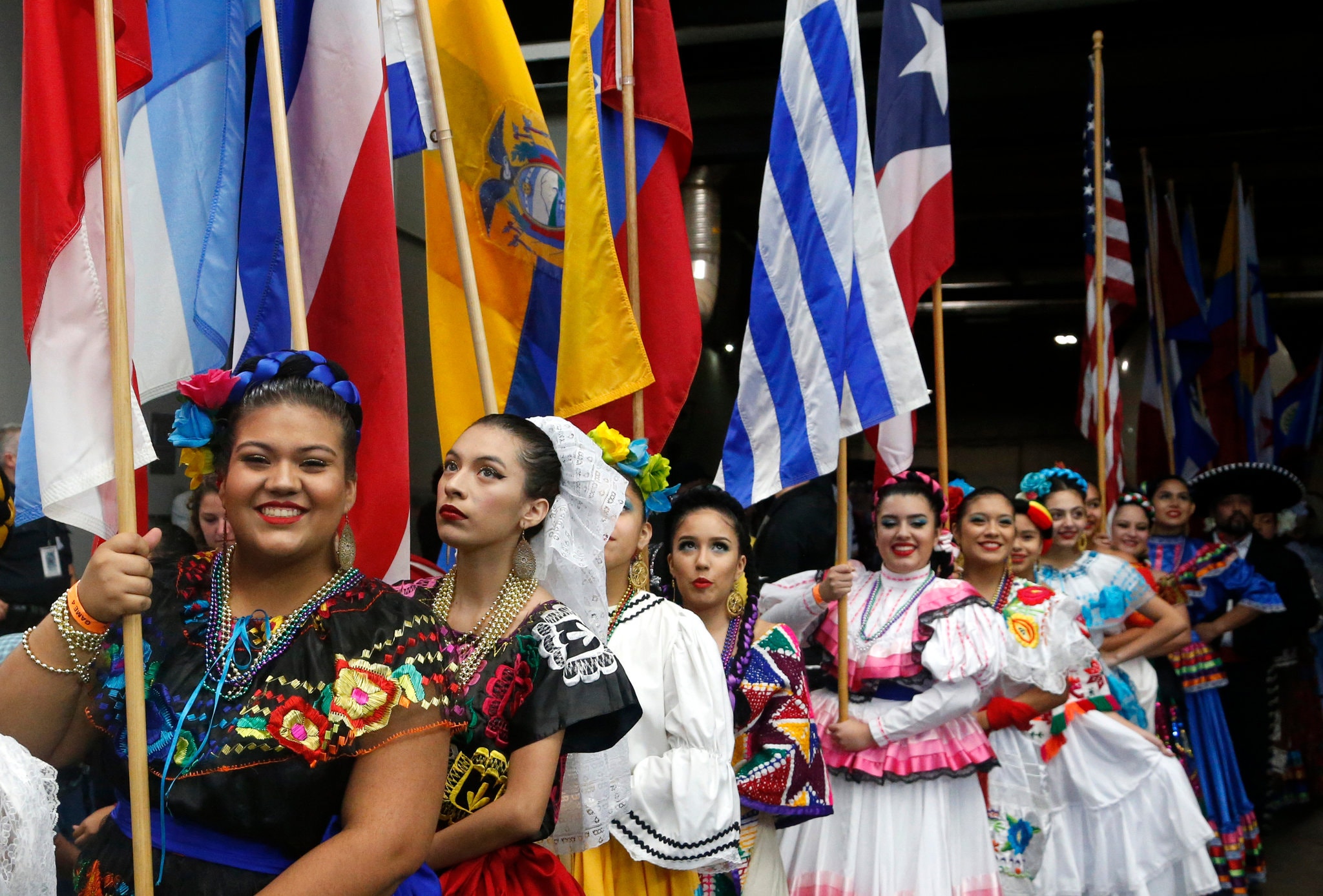 Women bearing flags in a 2017 Hispanic Heritage Month celebration.